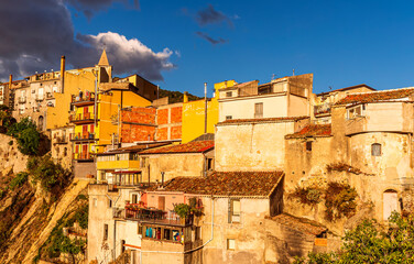 old mediterranean mountain dense town with levels of yellow houses and terraces on a mountain in...