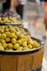 Different marinated olives and local food on street market in Gdansk, Poland. Selling and buying...
