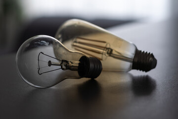 Power energy saving concept. light bulb with light on on gray background.