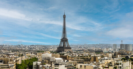 Panoramic view of the famous  Eiffel Tower in Paris with rooftops and skyline. Wide landcsape of the french monument.