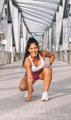 Portrait of a middle-aged woman in sportswear exercising in the city