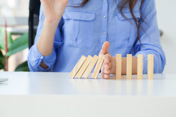 Hand holds wooden blocks, the concept of stopping the crisis