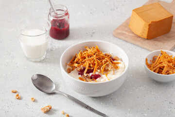 rice pudding with Norwegian brunost traditional brown cheese and raspberry jam
