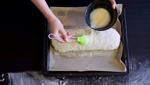 The process of making dessert, wrapping the dough in a roll, preparing strudel for baking, home baking