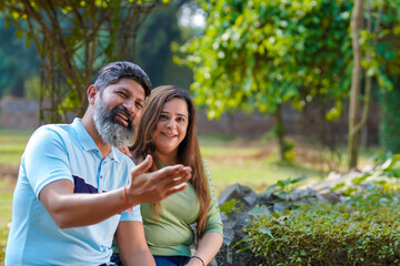 Fototapeta premium Young indian couple enjoying and spending quality time at park.