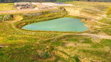 Fototapeta na wymiar Aerial view on a small blue lake in the countryside.