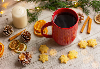 hot drink in a red cup next to cookies and spices on the table. winter holidays, Christmas, New Year