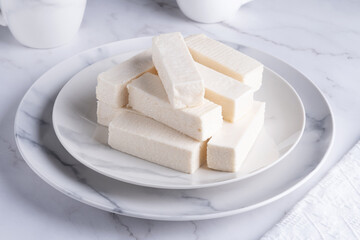 Vanilla pastille in a plate on a white table