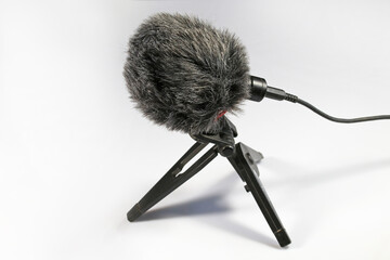 Microphone with wind protection on a plastic stand. Sound recording device.