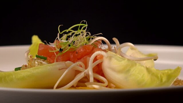 Recipe for salmon gravlax salad, endives filled with creame fresh, chives, yellow chioggia beetroot and leek shoots, white balsamic vinegar sauce. High quality video
