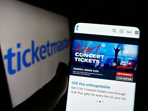 Stuttgart, Germany - 12-02-2022: Person holding smartphone with webpage of US company Ticketmaster Entertainment Inc. on screen in front of logo. Focus on center of phone display.