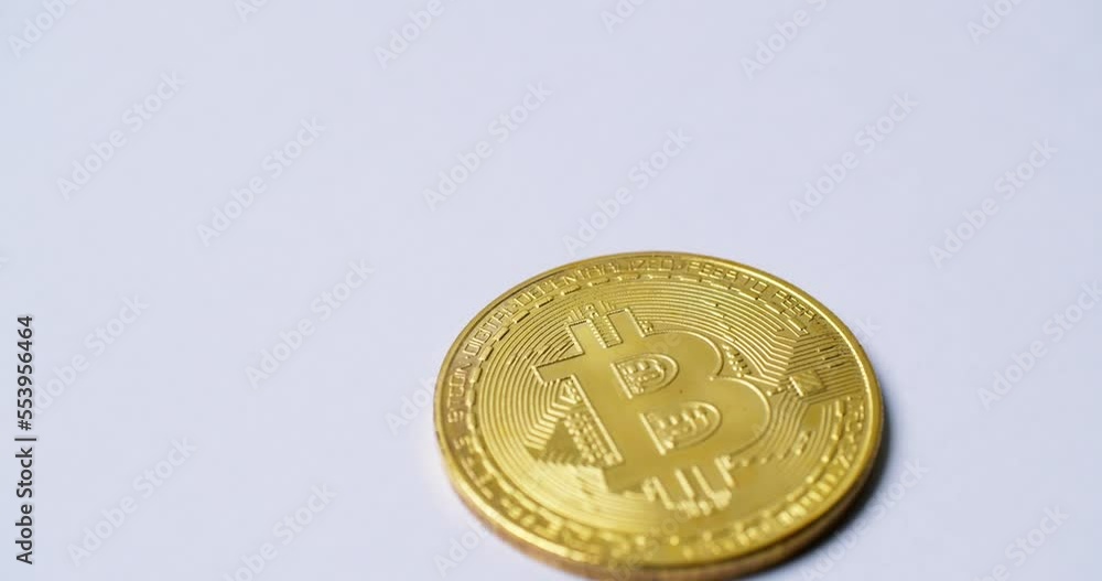 Poster close up the golden virtual coin with the bitcoin symbol isolated and rotated on white background. s