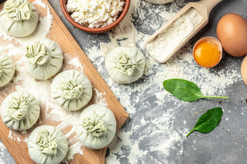 Khinkali with cheese and spinach. Raw semi-finished products dumplings. cooking khinkali. National Georgian cuisine. banner, menu, recipe place for text, top view