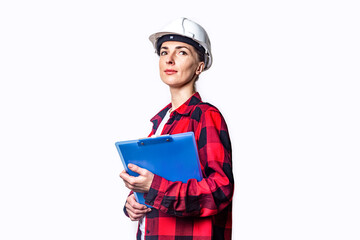 Young woman in construction clothes with clipboard on light background.