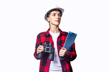 Young woman in construction clothes with a clipboard and binoculars on a light background.