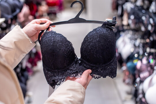 A woman in a store chooses lace underwear