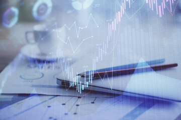 Forex graph hologram on table with computer background. Double exposure. Concept of financial markets.