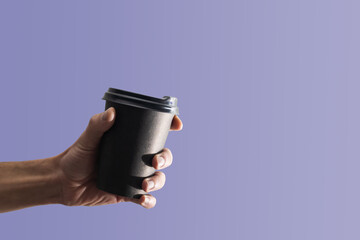 disposable cup of coffee in hand