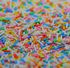 Fototapeta na wymiar Close up of multiple colorful sweet sprinkles over blurred background created using Generative AI technology