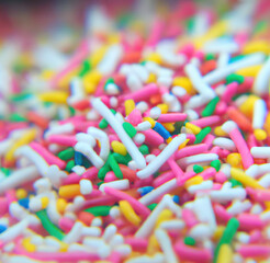 Close up of multiple colorful sweet sprinkles over blurred background created using Generative AI technology