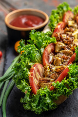 fresh delicious hotdog with onions. fried meat, tomatoes, lettuce and cheese sauce. banner, menu, recipe place for text, top view