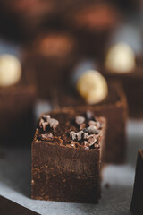 Homemade chocolate fudge with cocoa beans and hazelnuts.