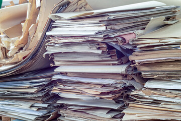 Old, randomly folded paper, as waste paper.