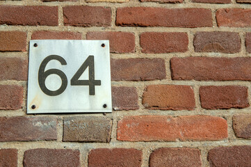 Fototapeta na wymiar Close Up Of House Number 64