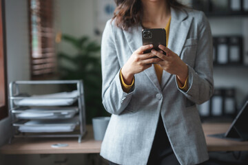 Woman using smartphone working with various applications. Including mobile transactions to send LINE messages and various business information send via social media.