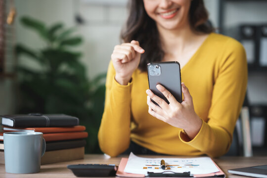 Woman using smartphone working with various applications. Including mobile transactions to send LINE messages and various business information send via social media.