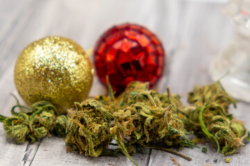 close-up photo of marihuana buds and christmas balls in the background