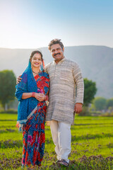 indian farmer with wife at agriculture field.