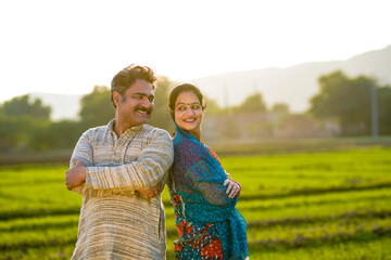 indian farmer with wife at agriculture field.