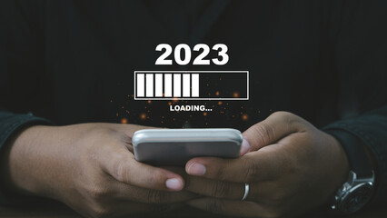 Countdown concept.Manhand waiting loading bar for countdown to 2023. Loading year 2022 to 2023.
