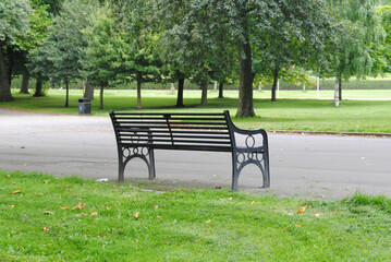 Empty Cast Iron Bench beside Path in Public Park 