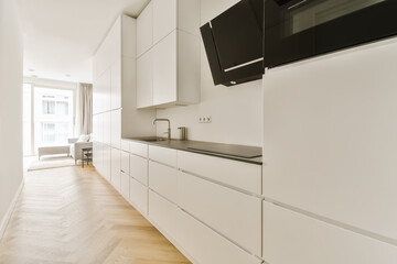 a kitchen with white cupboards and black appliances on the counter tops in this room is very clean,...