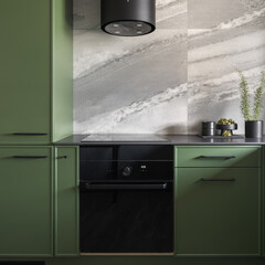 Black oven in trendy green kitchen