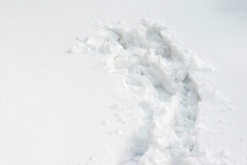 Man footprints in a winter snow. Human trace in deep snow.