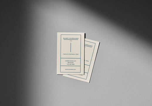 Overhead Mockup of Two Vertical Business Cards on a Grey Background