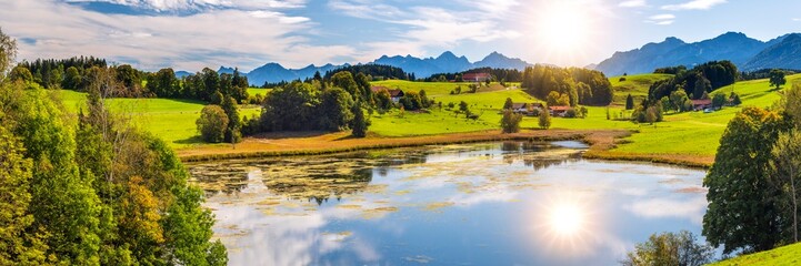  panoramic view to rural scene with lake and mountain range © Wolfilser
