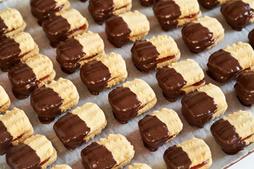 Traditional Christmas cookie filled with strawberry marmalade and dipped in chocolate