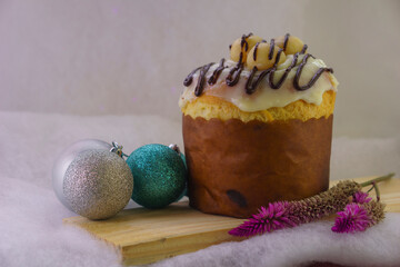 Homemade Christmas panettone made with fruit, chocolate or other fillings, can be covered, a culinary resource for the Christmas season, served alongside decorations with Santa Claus and donuts, 