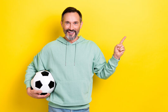 Portrait of sporty bearded man arm direct empty space recommend buy tickets international league isolated on yellow color background