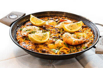 Close-up of typical delicious spanish paella with seafood in serving size