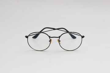 a close up of eyeglasses with black frames isolated on white background