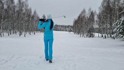 Golf in snow with ball golfer with club