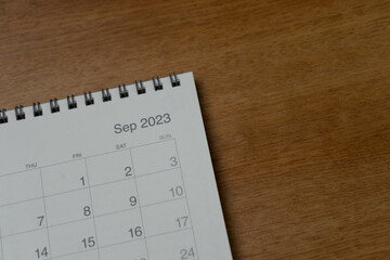 September 2023 calendar page on wood background. Calendar background for reminder, business planning, appointment meeting and event.