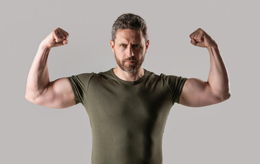 muscular strong man in studio. photo of strong muscular man with stubble. strong muscular man