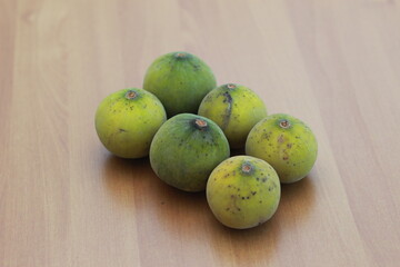 greenish yellow harp fruit isolated on money table has sweet and sour taste. Food concept photo.