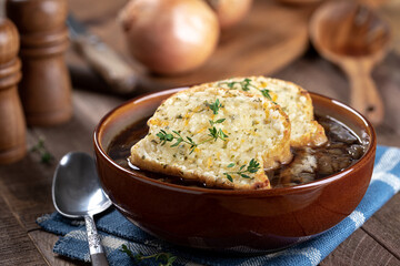 French onion soup with toasted cheese baguette garnished with thyme